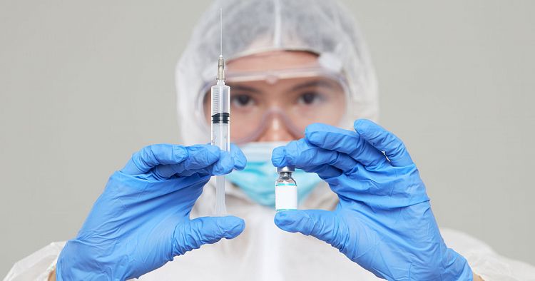 Scientist testing holding a syringe and vaccination. 